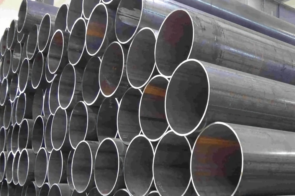 stacked high quality erw steel line pipes for natural gas and oil transportation stored in a factory warehouse.